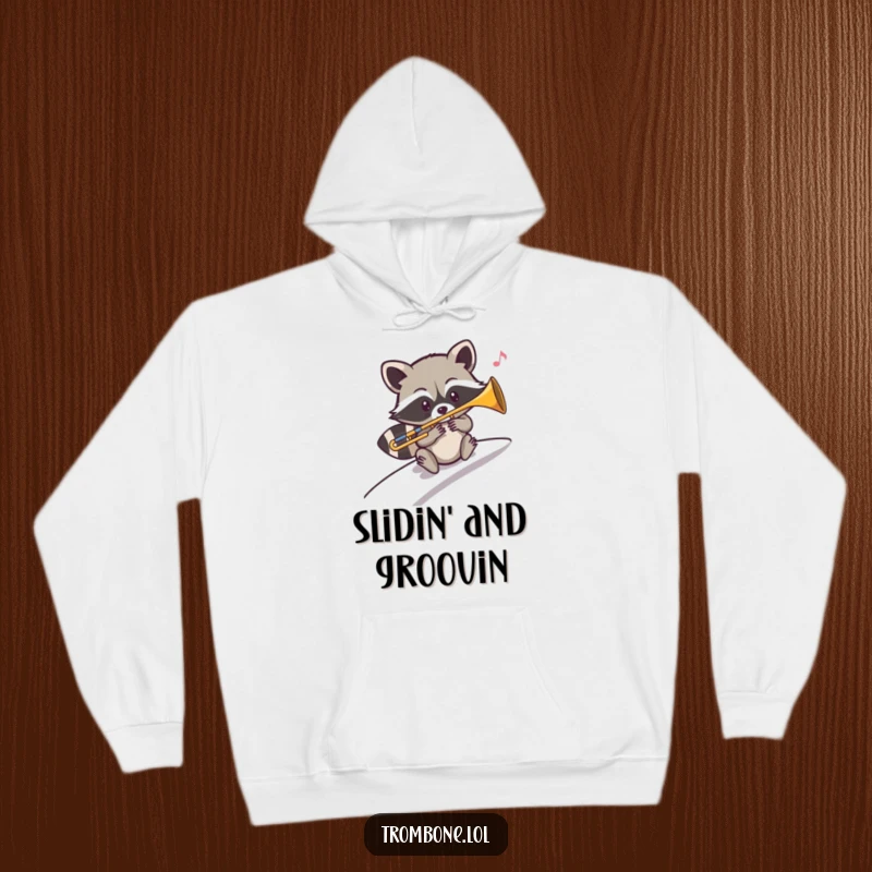 Funny hoodie graphic of a mischievous raccoon smoothly sliding down a slope while playing a trombone with jazzy flair.